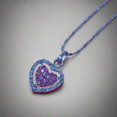 Dual Heart Pendant: A Stunning Silver Necklace Decorated with an Beautiful Pink & Silver Gems