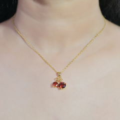 Ruby-Like Gemstone Pendant with Golden Bow
