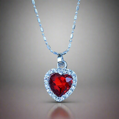 Pendant Shaped Like Heart with Red Stone & Small Silver Gems Around it, Plus a Silver Chain